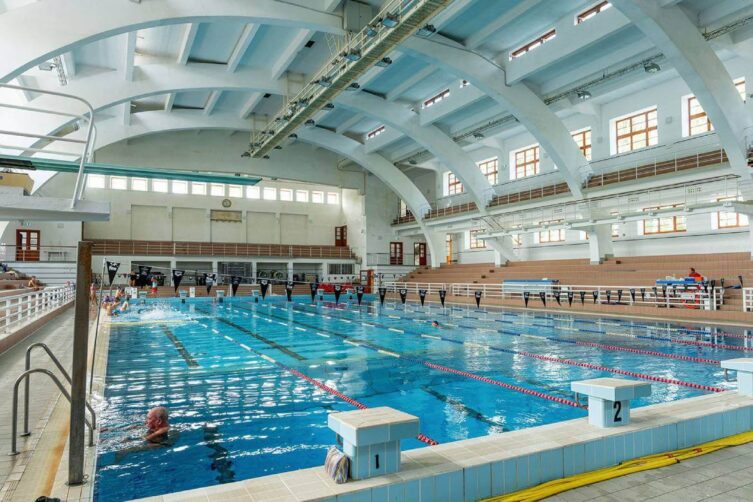 The renovated indoor pool with the iconic reinforced concrete arches